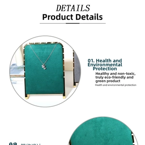 Detail view of emerald green suede necklace display stand with golden metal accents