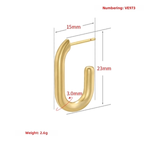 Macro detail of U-shaped gold earrings showing dimensions 23mm height and 15mm width