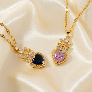 Elegant heart crown pendant necklaces with zircon inlay on luxury satin background
