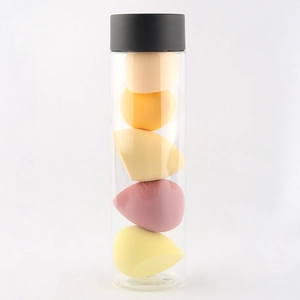 Set of 5 colorful makeup sponges in different shapes inside a transparent storage tube