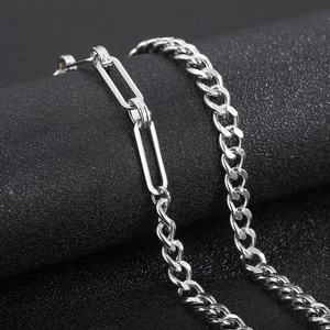 Macro shot of silver stainless steel paperclip and Cuban link chain necklaces