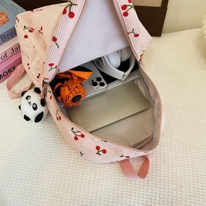 Interior view showing the large capacity of the pink corduroy cherry school backpack