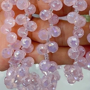 Detail of 6mm pink faceted crystal glass beads held in hand for jewelry making diy