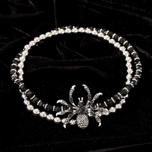 Detailed close-up of double-layer spider pendant necklace with black beads and rhinestones
