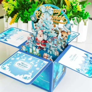Macro shot of 3D Christmas card box with Santa, reindeer, and festive holiday pop-up scenes