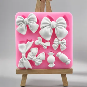 Pink silicone mold detail showing intricate bow and candy shapes for fondant and DIY crafts