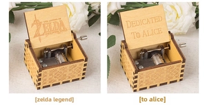 Detailed view of hand-cranked wooden music boxes with intricate metal gears and engravings