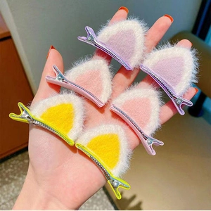 Close-up of six colorful plush cat ear hair clips with soft faux fur texture for girls