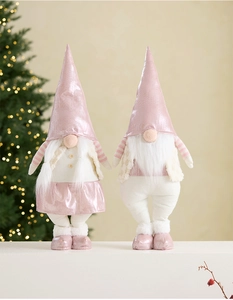 Detail of pink LED Christmas gnomes with plush textures and festive lights in background