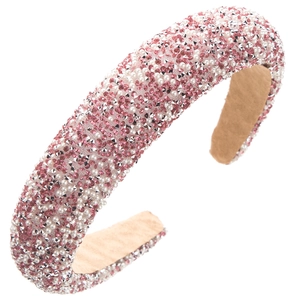Detail of pink rhinestones and white pearls on a thick padded sponge headband