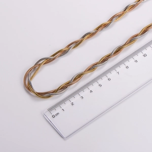 Detailed view of tri-color woven stainless steel necklace with size measurement ruler