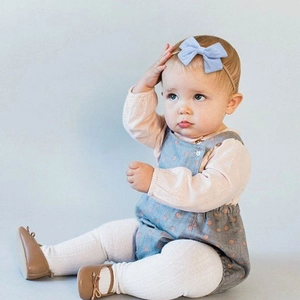 Soft light blue ribbed nylon baby headband with a cute bow for infants and toddlers