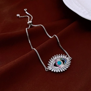 Macro detail of silver evil eye bracelet with turquoise and colorful cubic zirconia