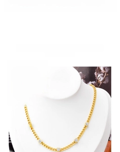 Detail of titanium heart necklace with shimmering crystals on a gold cuban link chain