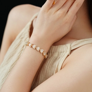 Close-up of double-layer heart bracelet with sparkling zircon stones on female wrist