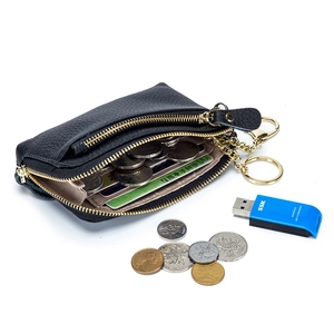 Minimalist black pebble leather coin purse with double zippers and gold keychain hardware