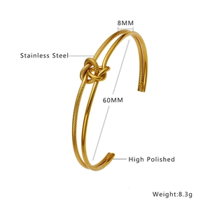 Detailed view of gold stainless steel knot bracelet with textured and polished finishes