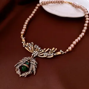 Vintage necklace set with champagne pearls and a green water-drop emerald pendant