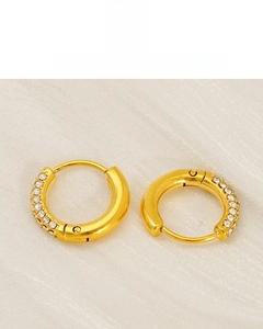 Close-up of 18K gold plated titanium earrings featuring sparkling cubic zirconia stones