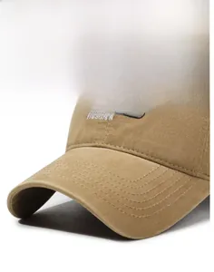 Detail view of khaki cotton baseball cap brim with reinforced stitching and fox embroidery