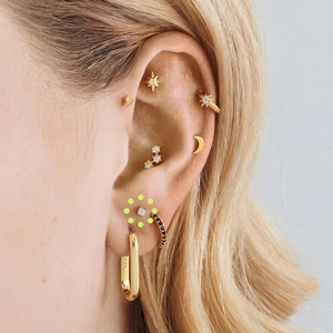 Close-up of S925 sterling silver gold earrings set with zircon studs and hoop on ear
