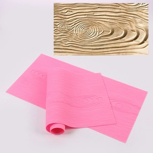 Pink silicone bark texture mat for cake decorating with detailed wood grain pattern