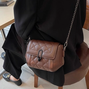 Brown quilted leather crossbody bag with black lock and metal chain strap for women