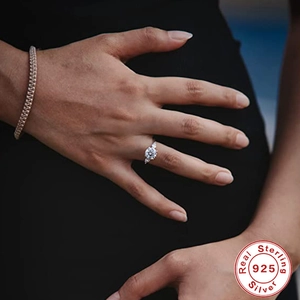 Close-up of sterling silver three-stone engagement ring with sparkling round diamonds