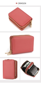 Detail of crimson pebbled leather card holder with dual gold zippers and accordion slots