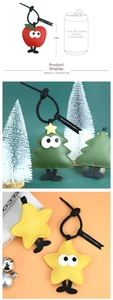 Detail view of Christmas tree and apple PU leather keychains with dimensions and lanyard