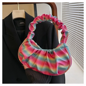 Detail of vibrant rainbow gradient pleated texture on a soft nylon shoulder bag