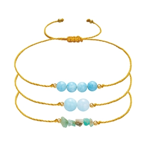 Detailed view of three-piece woven bracelets with amethyst and irregular natural stones