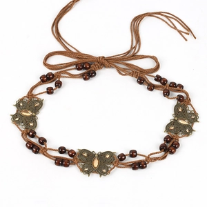 Close-up of woven rope belt featuring metal butterflies and amber resin beads