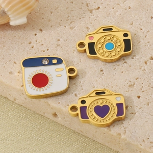 Three creative camera-shaped charms with colorful enamel finish on beige stone
