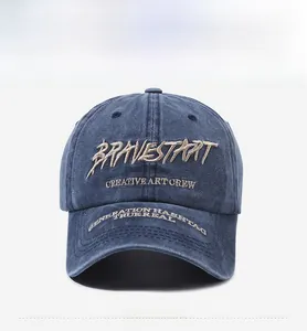 Detailed close-up of 3D embroidery and vintage washed denim texture on a baseball cap