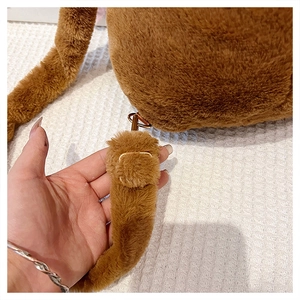 Detail of adjustable strap and metal hardware on the Capybara plush backpack