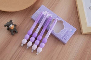 Detail of ergonomic soft grip gel pens with gradient purple barrels and cute bunny patterns