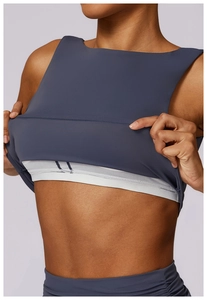 Detail of slate blue yoga top showing elastic underband and seamless layered fabric