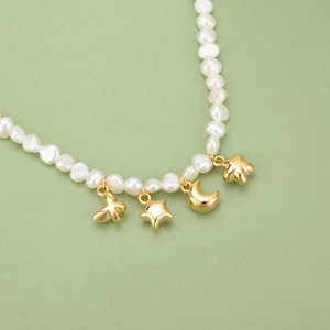 Baroque pearl necklace featuring 18k gold plated butterfly, star and moon pendants