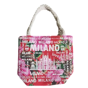 Red canvas tote bag with floral Milano print and white rope handles on white background