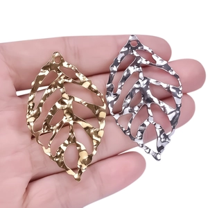304 stainless steel leaf pendants in gold and silver with hammer texture on hand