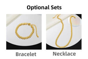 Detailed close-up of golden stainless steel heart chain necklace and bracelet set