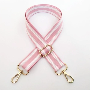 Adjustable pink and white striped woven bag strap with golden metal swivel hooks