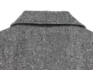 Close-up detail of the herringbone wool blend fabric on a French style blazer lapel