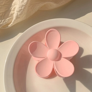 Close-up of pink flower hair claw clip in matte resin finish for girls and women