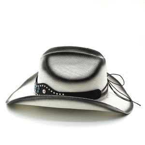 Detail of western straw cowboy hat with silver gradient finish and turquoise studs