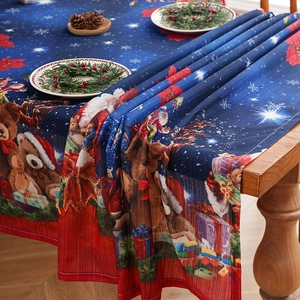 Detailed fabric texture of a festive Christmas tablecloth with Santa and reindeer patterns