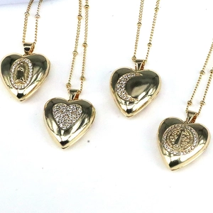 Set of four gold heart locket necklaces with crystal inlay and virgin mary moon pendants
