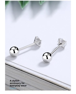 Macro view of four-prong set sparkling zircon stud earrings with screw-back ball design