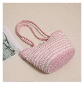 Close-up of pink and white striped woven tote bag with a decorative pearl clasp closure